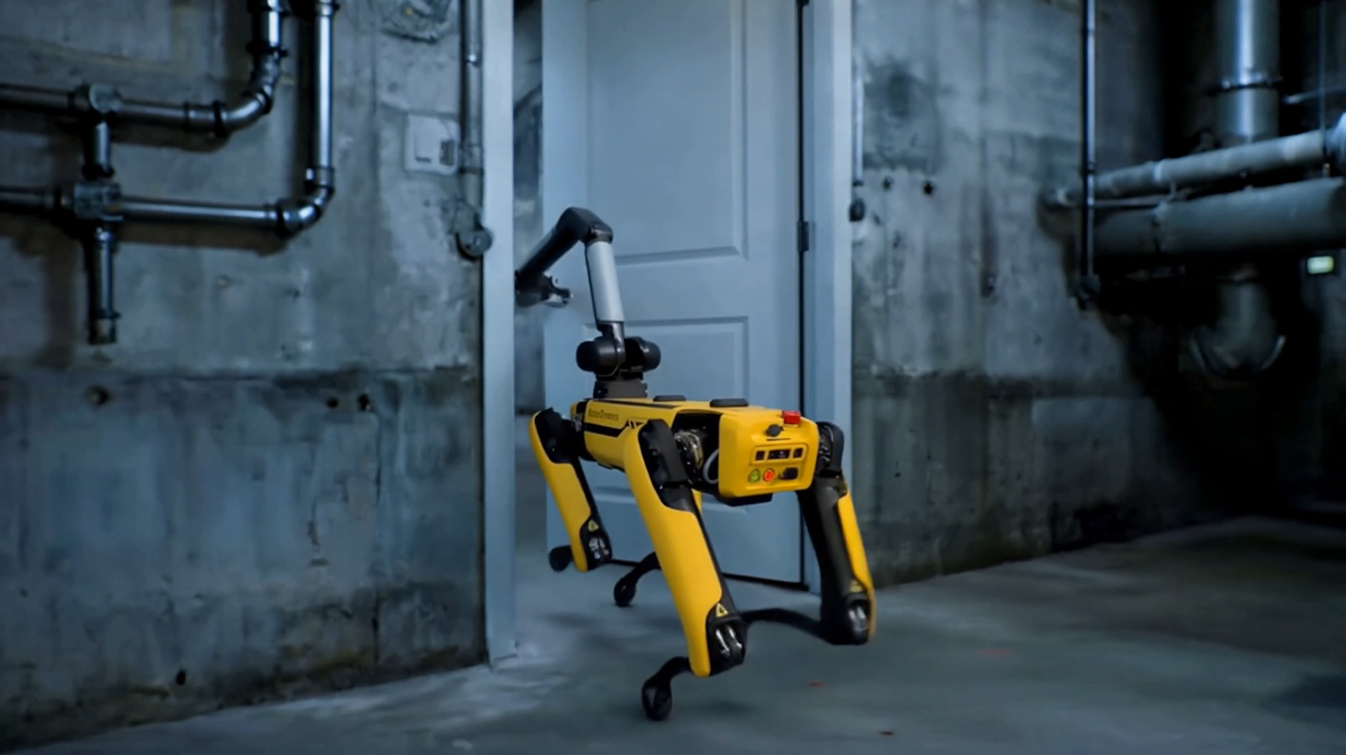 Quadruped robot opening a door in an industrial facility